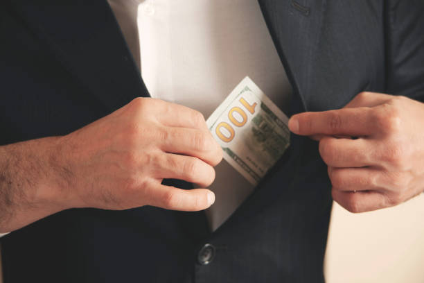 istock man hand money on suit pocket on grey background 1392578779