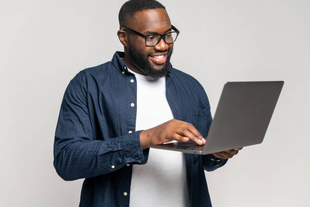 istock Smart and concentrated African-American businessman using a laptop 1392578906