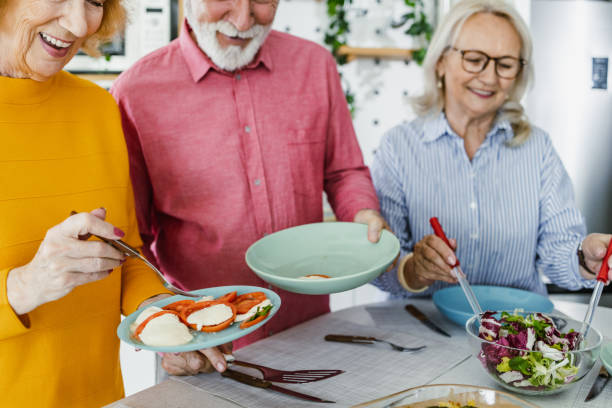 istock Senior preparing food and enjoying lunch 1392579219