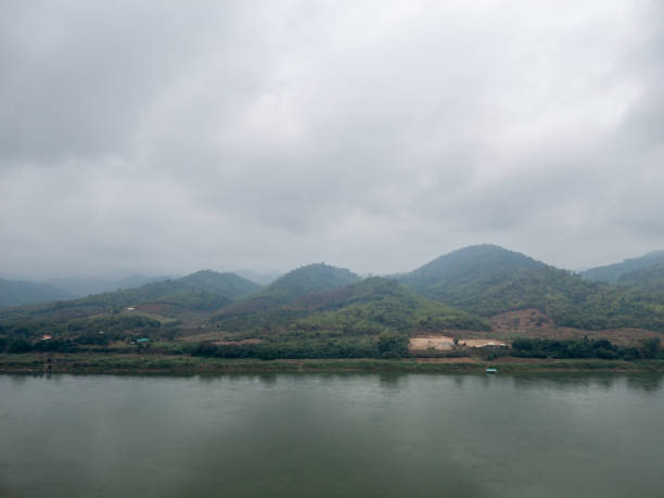 istock The mountain range is covered by clouds near the large river. 1392580350