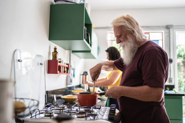 istock Senior man cooking at home 1392582115
