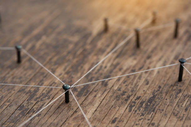istock Network connected with yarn white on plank wood 1392582243