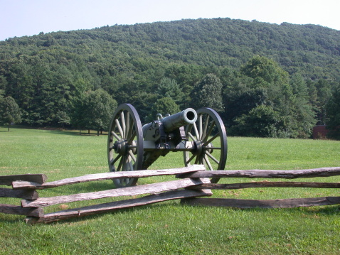 A cannon from the civil war with Kennesaw Mountain in the background.