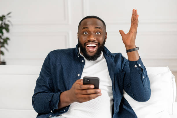 istock Cheerful black guy celebrating lucky and victory 1392582846