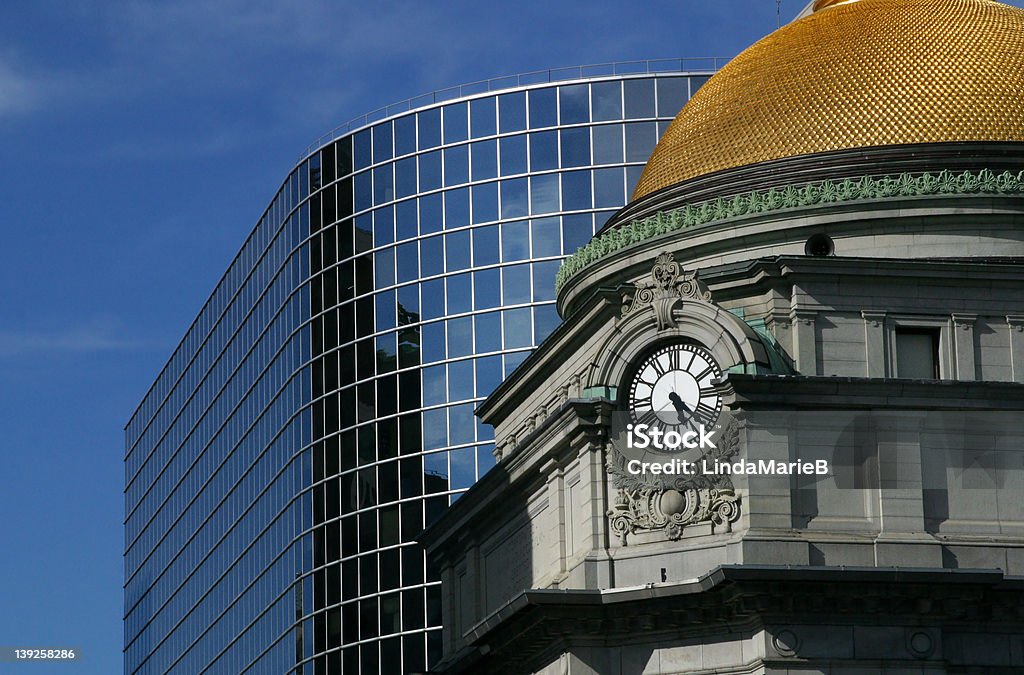 Gold Dome and Modern Building A clock tower with a gold dome, in front of a modern building. The dome has a scalloped texture. Buffalo - New York State Stock Photo
