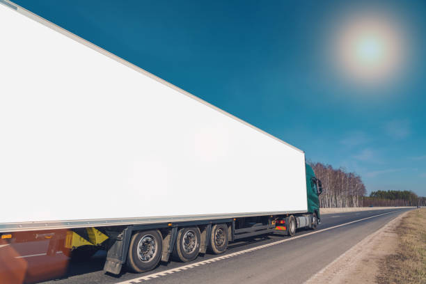 istock Heavy auto train with blank long commercial banner driving on highway 1392583418