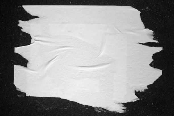 istock A piece of paper on a black wall. 1392583422