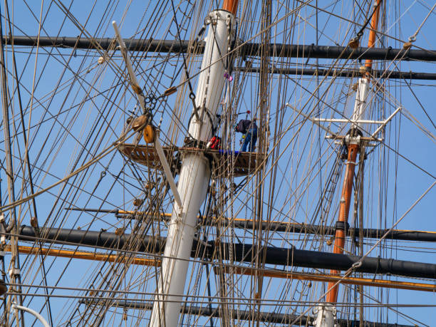 man working in the rigging on the cutty sark - sailing ship nautical vessel rigging industrial ship imagens e fotografias de stock