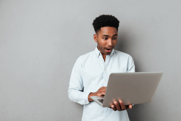 istock Excited afro american man looking at laptop computer screen 1392584278