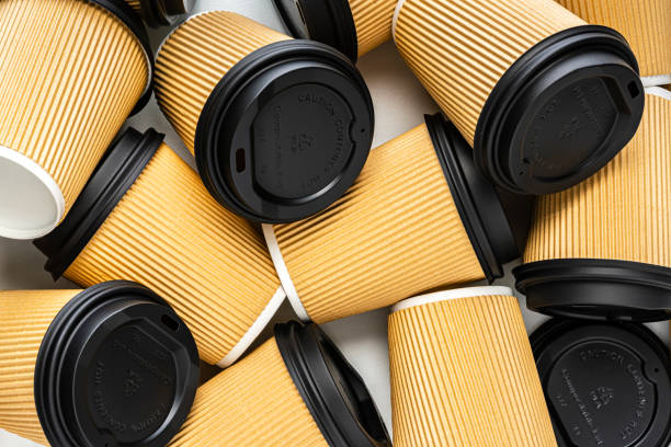 istock Disposable brown paper coffee cups background 1392584623