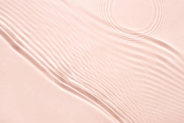 istock The texture of water on a pink background. 1392586009