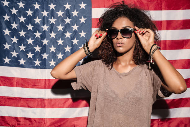 istock Serious african young lady wearing sunglasses 1392588517