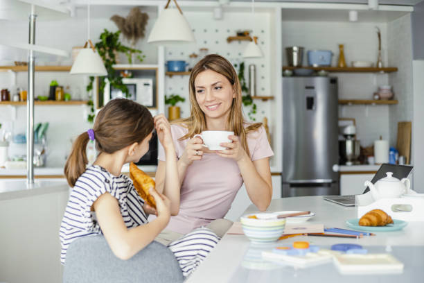 istock Mother and daughter having breakfast at home 1392588645