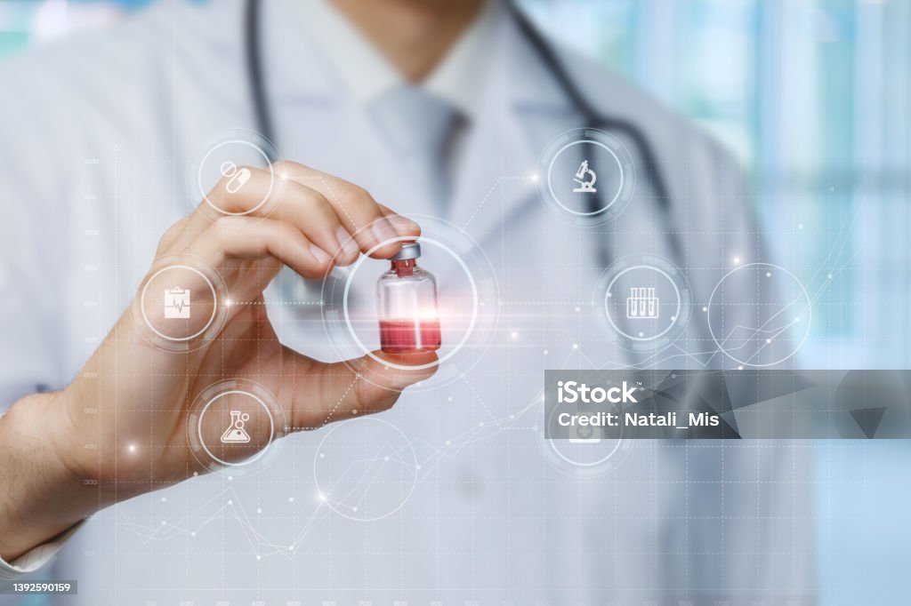 Doctor shows a medicine for treatment . Doctor shows a medicine for treatment on the background of a virtual computer screen. 20-24 Years Stock Photo