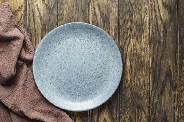 istock Empty bluish plate on oak wooden background 1392591683