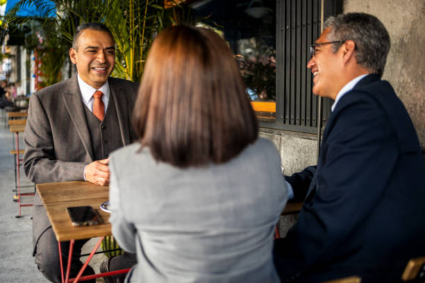 istock Colleagues sitting in a cafe 1392594402