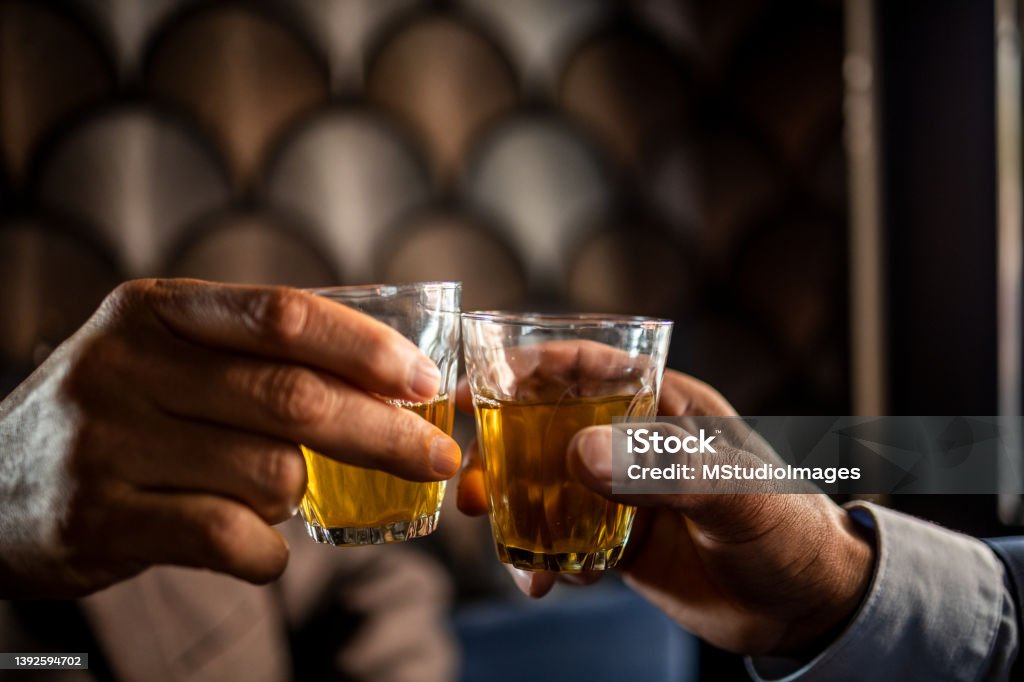 Close up on men hands holding glass of tea Close up on human hands holding glass of tea Happy Hour Stock Photo