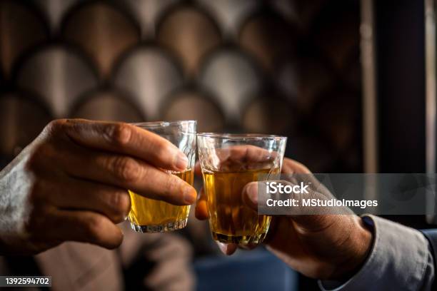Close Up On Men Hands Holding Glass Of Tea Stock Photo - Download Image Now - Happy Hour, After Work, Drinking