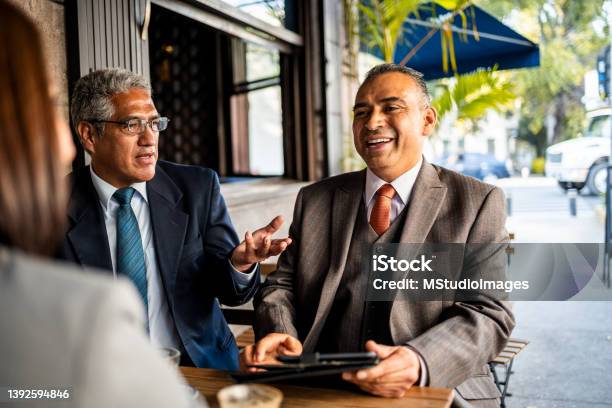 Business People Sitting At Restaurant Stock Photo - Download Image Now - Meeting, Business Lunch, Corporate Business