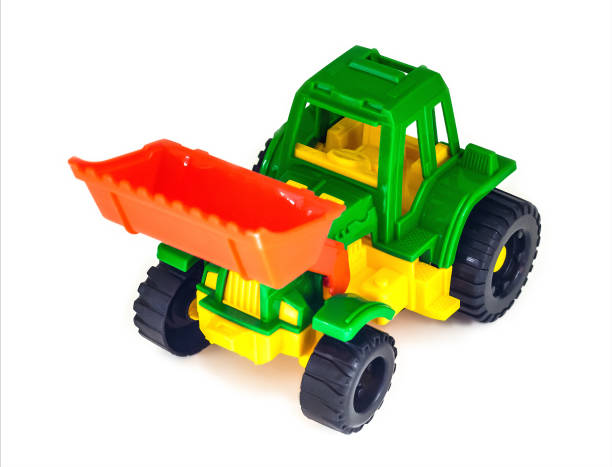 istock colorful plastic toy wheeled tractor loader excavator, isolated 1392594861