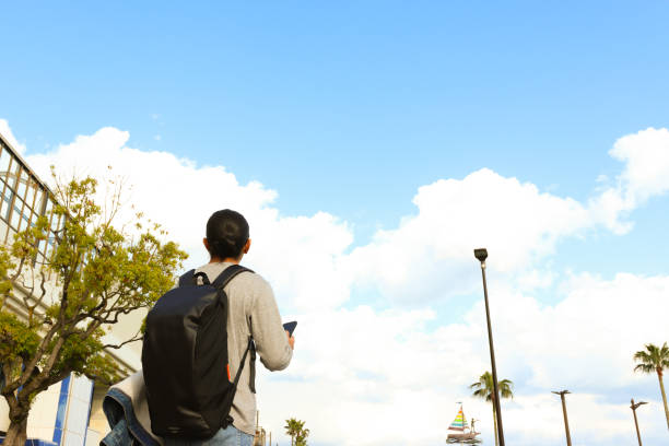 Authentic candid moments while traveling.  Young Asian man having arrived or are departing for a vacation and include luggage