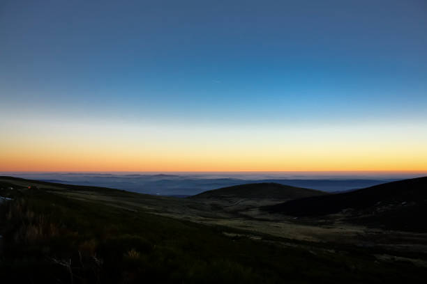 Orange sunset over the hills at golden hour in Sanabria region in Spain