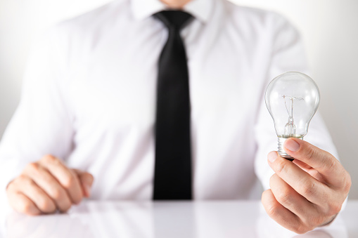 New idea concept with businessman holding a light bulb