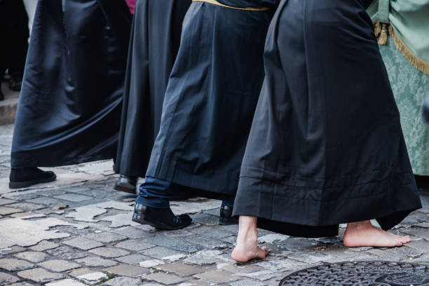 istock barefoot brotherhood member pushing an image during Holy Week 1392602477