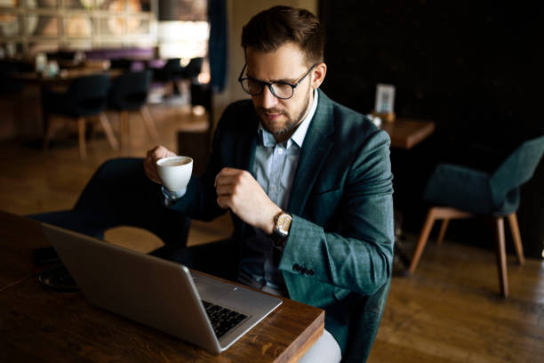 istock Businessman working on laptop and drinking coffee 1392602695