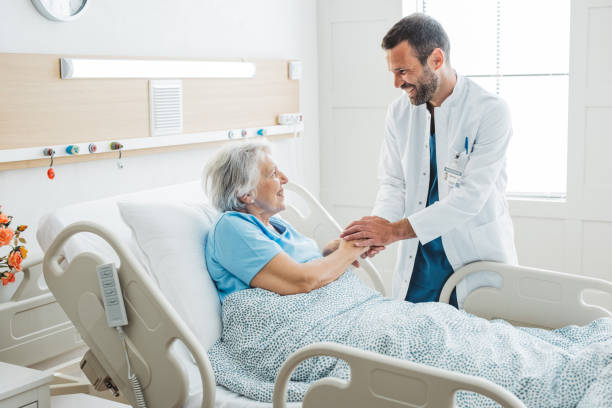 Senior woman in hospital bed stock photo