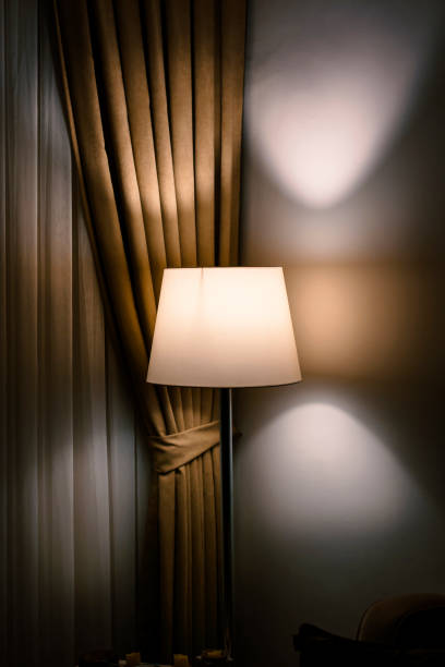 istock lamp and curtain in the dark room 1392605528