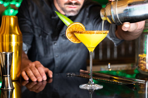 istock Bartender serving a cocktail in a night club bar 1392606809