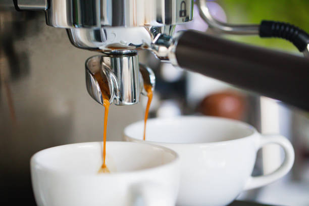 istock Coffee espresso pouring into 2 white cups 1392607840