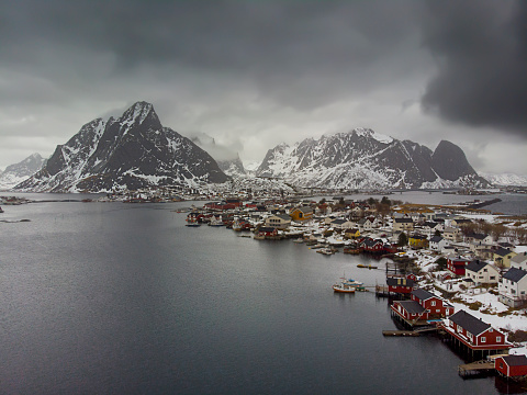 Aerial view of The Reine fisdherman village bay taken with a drone in winter - Lofoten Islands - Norway