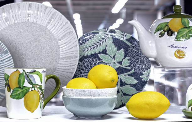 istock Juicy yellow lemons on the table with a cup and teapot with lemon pattern. 1392609201