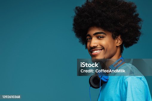 istock African american man with african hairstyle using phone 1392610368