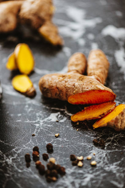 istock Sliced fresh ginger and turmeric with pepper 1392611441
