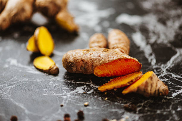 istock Sliced fresh ginger and turmeric with pepper 1392611472