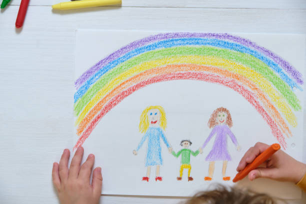istock Crop kid drawing LGBT family on table 1392611588