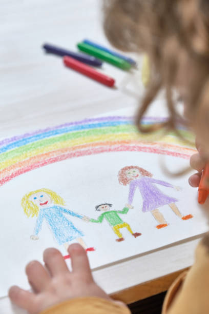 istock Crop kid drawing mothers and child 1392611593