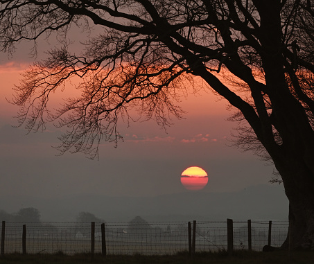 Dawn breaks in the English countryside near Stonehenge in Wiltshire