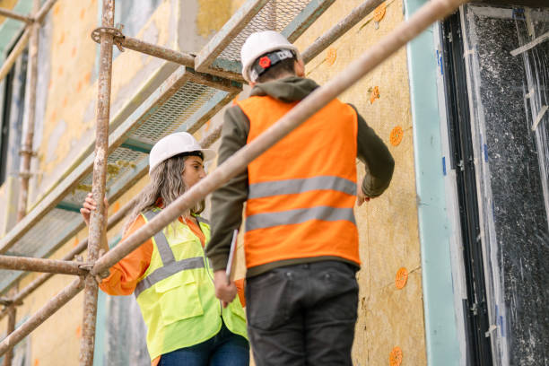 istock Female architect and construction worker on scaffolding 1392613095