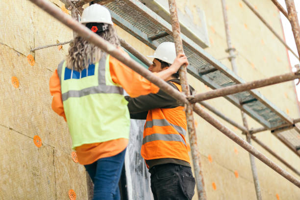 istock Female architect and construction worker on scaffolding 1392613130