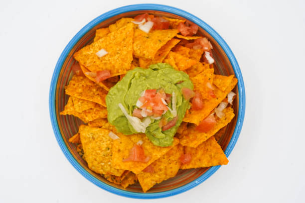 Nachos with cheese, meat, guacamole and tomato