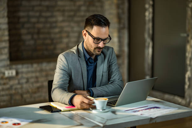 istock Young businessman working on laptop in the office. 1392616812