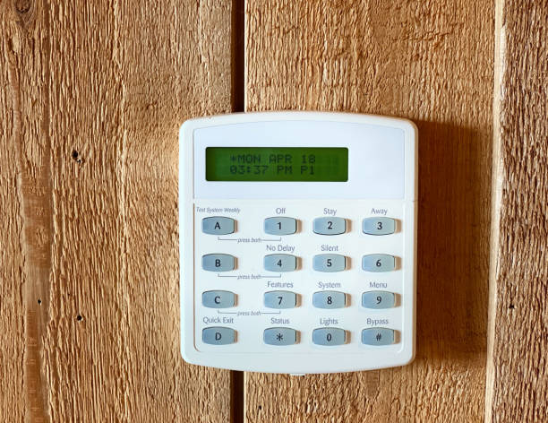 istock Digital Thermostat on wooden wall with buttons and display screen 1392621247
