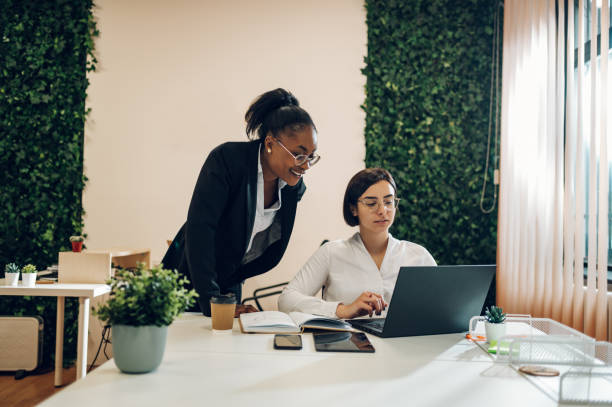 istock Two multiracial businesswoman working together in an open space office 1392622468