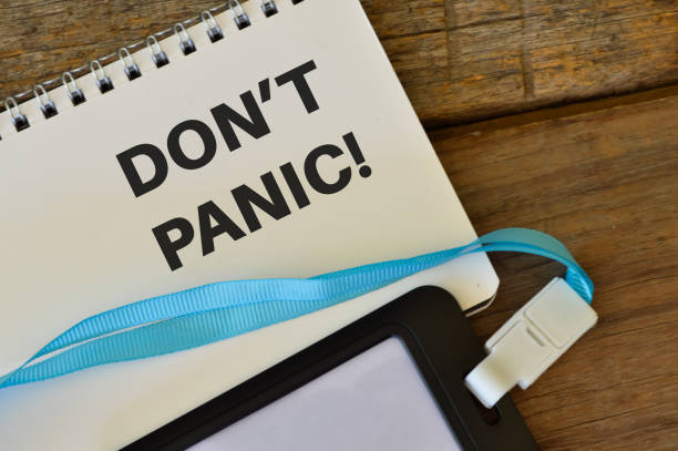 istock Notebook written with text DON'T PANIC over wooden background. 1392623143