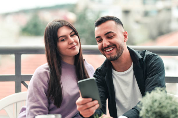 istock Selfie By Smiling Couple Relaxing On Balcony 1392624120