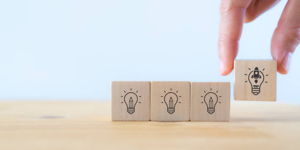 istock Launching idea, startup business concept. Beyond competitors, good plan, successful goal concept. Hand holds wooden cubes with 